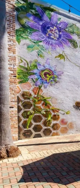 Purple passion flower mural on brick wall in downtown Panama City